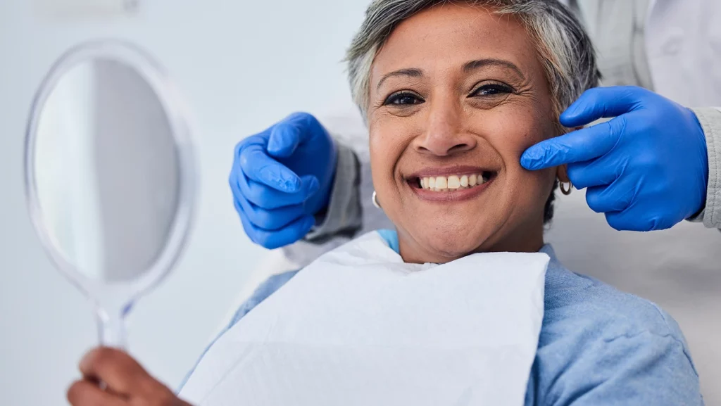 Happy senior woman, teeth and dentist for dental care, appointment or checkup at clinic. Portrait of elderly female person smile for tooth whitening, cleaning or oral, mouth and gum care at hospital