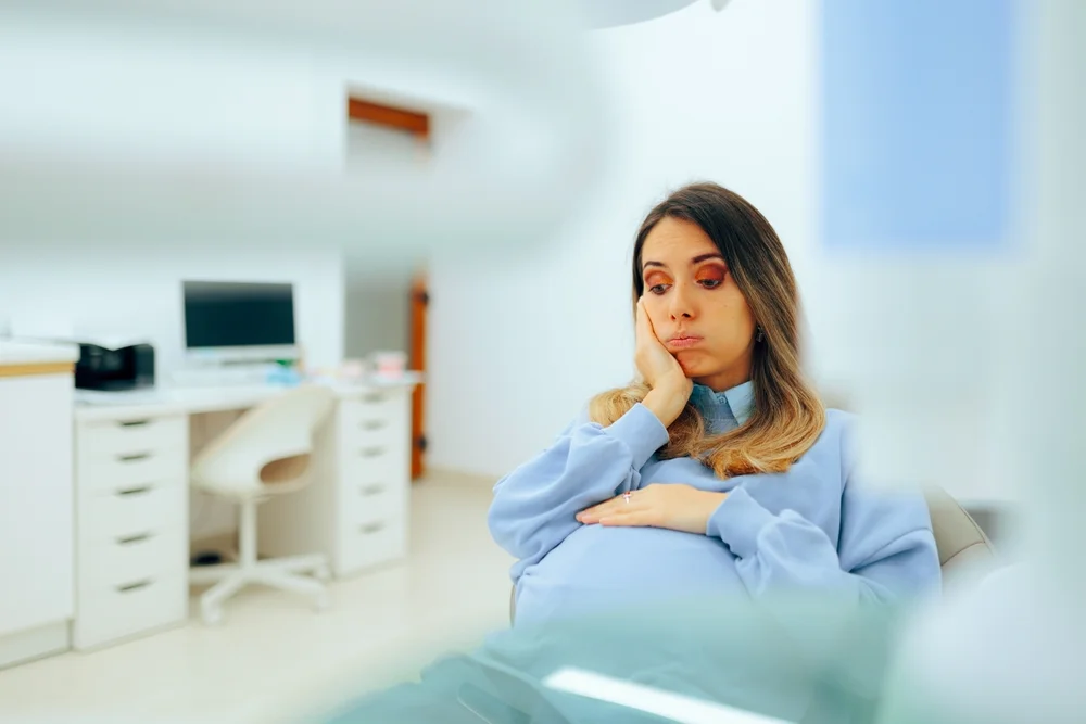 Pregnant Woman Having Dental Problems in Need of Treatment Mother to be suffering from gingivitis and other health issues